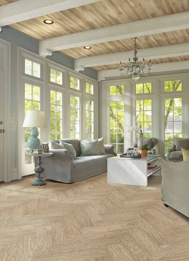 light toned wood look laminate in a bright living room with large windows