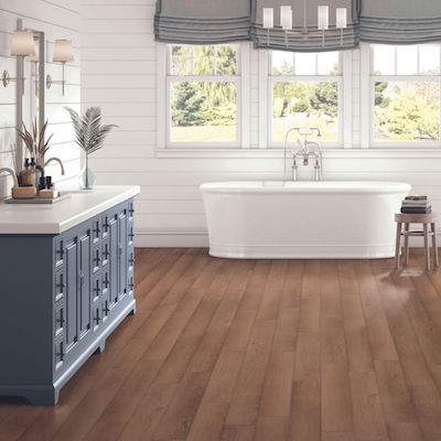 bathroom design with freestanding tub, vanity and large windows
